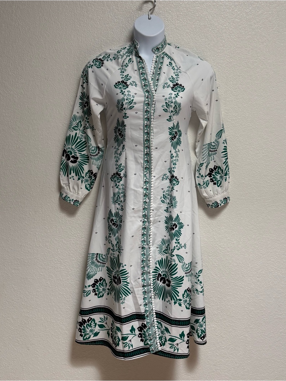 White dress with Green and Black Floral Trim